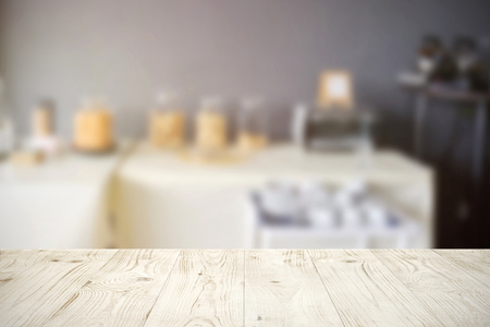 Empty wooden board table top on blur abstract of restaurant or catering background, for montage product or display, mock up for display of productの写真素材