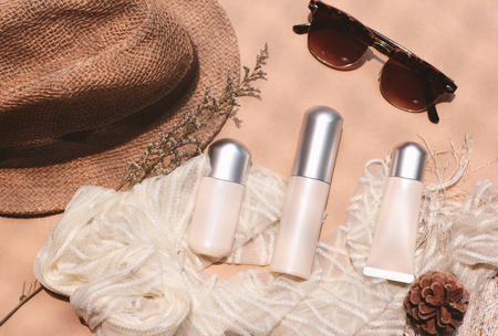Cosmetic blank plastic tube and bottle design mockup and eyeglasses with hat, lifestyle and beauty concept, retro style toneの写真素材