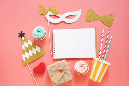 Cute party props, cake, blank notebook and gift box on colorful background, happy new year party celebrationの写真素材