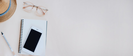 Flat lay of workspace desk with stationery and accessories in minimal style, copy space and banner style for textの写真素材