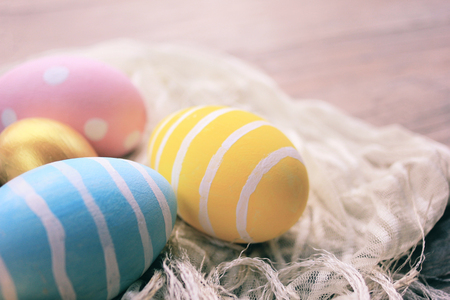 Pastel and colorful easter eggs on cloth with copy space, happy easter holiday conceptの写真素材
