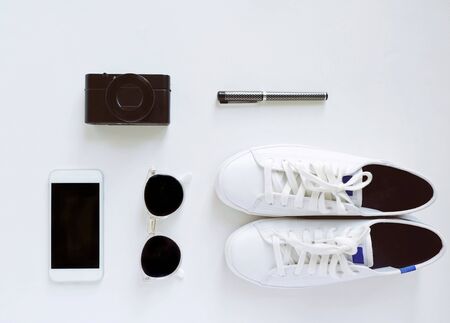 Flat lay of travel items, sneakers and accessories with smartphone on white background, fashion and lifestyle conceptの写真素材
