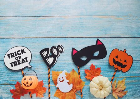 Flat lay of halloween prop for photo booth and party on blue wooden background with copy space, holiday concept の写真素材