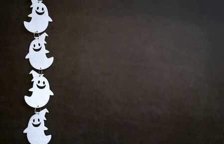 Top view of white ghost decoration on dark stone background with copy space, trick or treat for halloween の写真素材