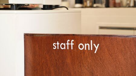 Close up of staff only sign at the wooden door cafe or restaurant の写真素材