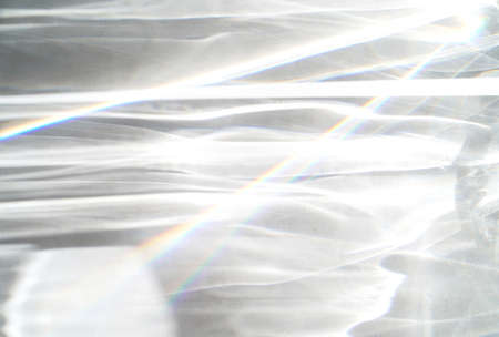 Water texture overlay effect, rays of light  shadow overlay effect with rainbow reflection of light from water on a white background, mockup and backdropの写真素材