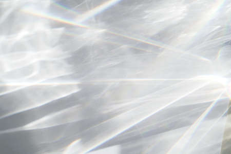 Water texture overlay effect, rays of light  shadow overlay effect with rainbow reflection of light from water on a white background, mockup and backdropの写真素材