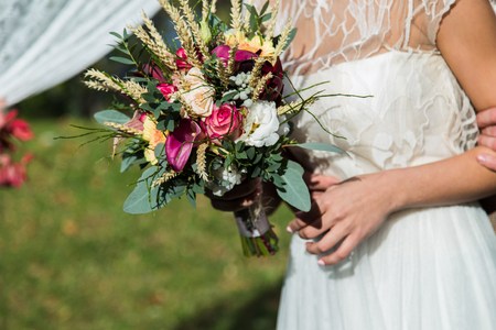 Bride with beautiful wedding bouqet, closeup shotの写真素材