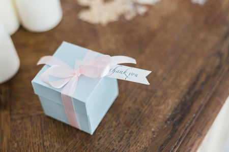 Blue gift box with lettering Thank you on wooden tableの写真素材