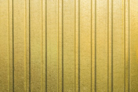 Texture background of yellow corrugated metall fenceの写真素材
