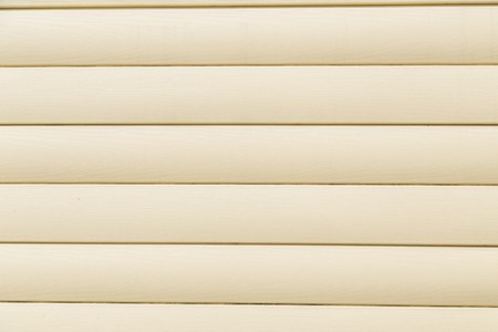 House siding. Yellow plastic panel siding texture.の写真素材