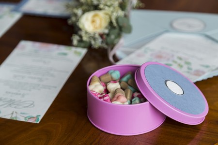 Box of candy 0n wooden table near flowers