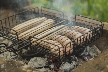Tasty grilled sausages on nature, green backgroundの写真素材