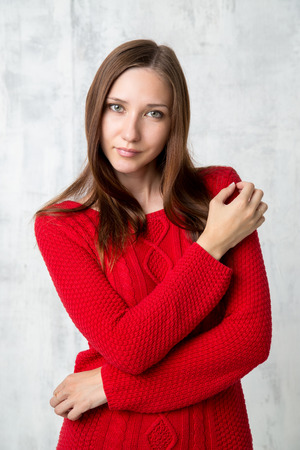 Head shot of an attractive young woman in red sweaterの写真素材