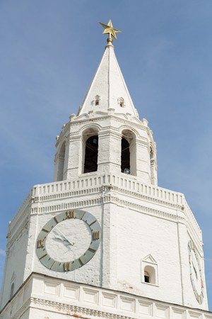 White clock tower agains blue skyの写真素材