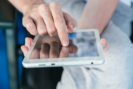 Man using a tablet pc on deck of shipの写真素材