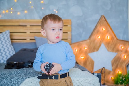 Portrait of little boy staying near bed with toyの写真素材