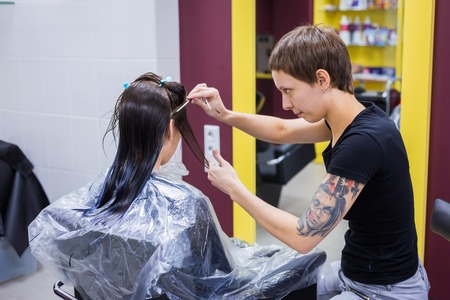 Professional hairdresser, stylist cutting hair of woman client at salon, studio. Beauty and fashion conceptの写真素材