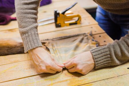 Professional male skinner, furrier working with mink fur skin at atelier, workshop. Fashion and leatherwork conceptの写真素材