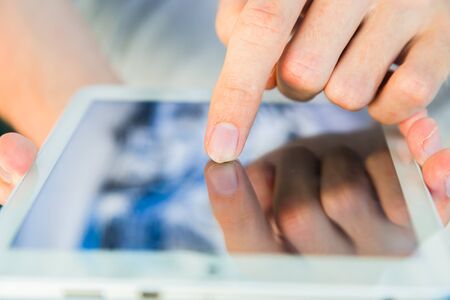 Man using a tablet pc on deck of ship