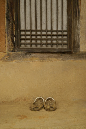 Traditional Korean paper windows and straw shoes,の写真素材