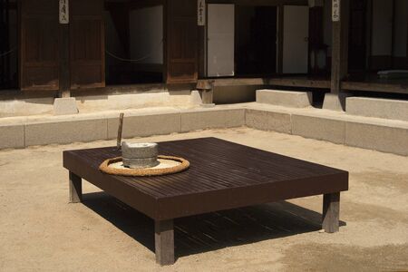 millstone, low wooden bench, Hanok, Korean-style house, Koreaの写真素材