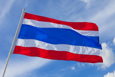 Image of waving Thai flag of Thailand with blue sky background.の写真素材