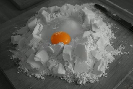 Black and white flour well with colored egg yolk