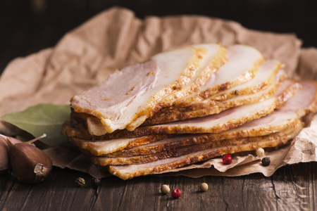 Boiled salted pork slices with spices over wooden table, rustic styleの写真素材