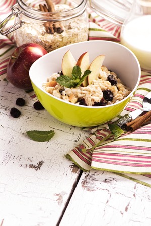 Oatmeal porridge with dry cranberry and appleの写真素材