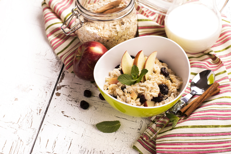 Oatmeal porridge with dry cranberry and appleの写真素材