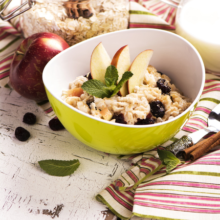Oatmeal porridge with dry cranberry and appleの写真素材