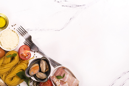 Pasta with ingredients over white marble table. Top viewの写真素材