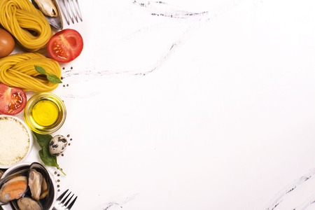 Pasta with ingredients over white marble table. Top viewの写真素材