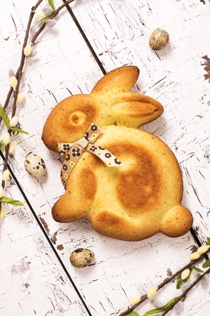 Easter bunny cake and eggs over white wooden backgroundの写真素材