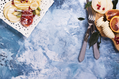 Fruit salad with pear, pineapple, pomegranate and banana, top viewの写真素材