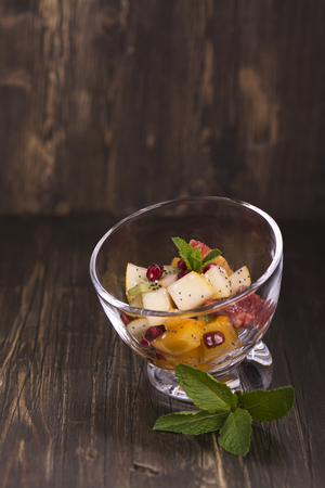 Fruit salad in glass bowls over dark wooden table. Selective focusの写真素材