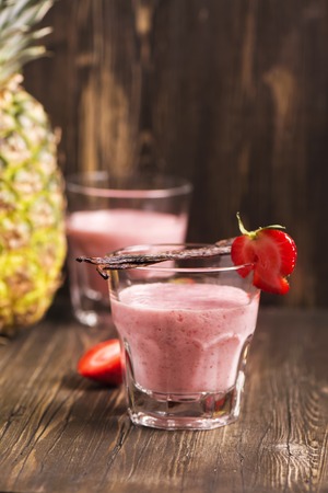 Fresh healthy strawberry and pineapple smoothie with vanilla. Toned imageの写真素材