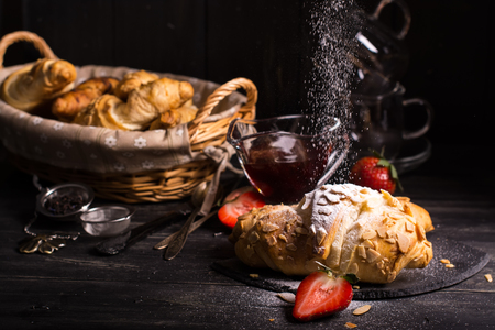 Fresh almond croissants strewing by sugar powder, vintage style.の写真素材