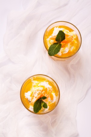 Layered panna cotta with whipped cream and tangerine sauce. Selective focusの写真素材