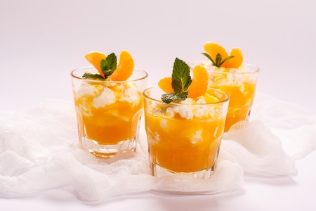 Layered panna cotta with whipped cream and tangerine sauce. Selective focusの写真素材