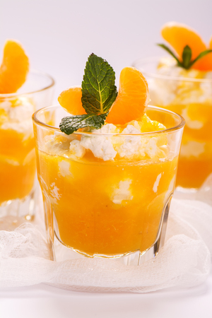 Layered panna cotta with whipped cream and tangerine sauce. Selective focusの写真素材