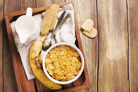 Tasty and healthy breakfast on wooden tray. Top view, toned image. Space for textの写真素材