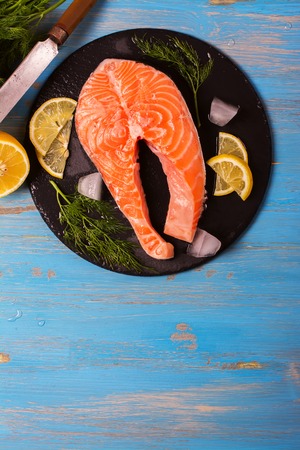 Raw salmon steaks and ingredients on slate background. Selective focus. Top viewの写真素材