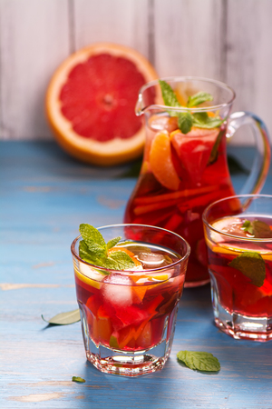 Jug and glasses with homemade citrus lemonade with mint and ice. Selective focusの写真素材