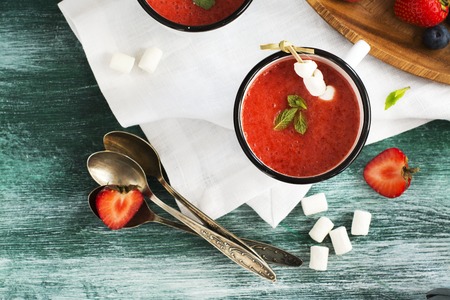 Strawberry smoothies in retro enamel mugs with mint and marshmallowsの写真素材