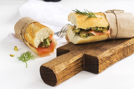 Sandwiches with smoked salmon, potato, pickled cucumbers and dill over white background. Selective focusの写真素材