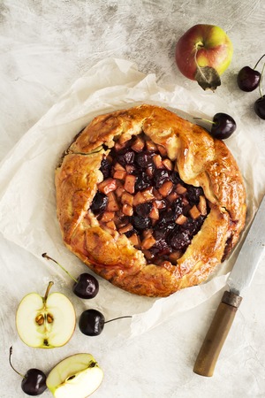 Homemade opened fruit pie with apples and cherries. Space for text. Selective focusの写真素材