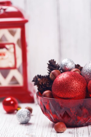 Christmas decorations on white wooden table. Balls, nuts, pine conesの写真素材