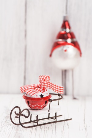 Xmas or new year composition with sledge, small bell and funny birdの写真素材
